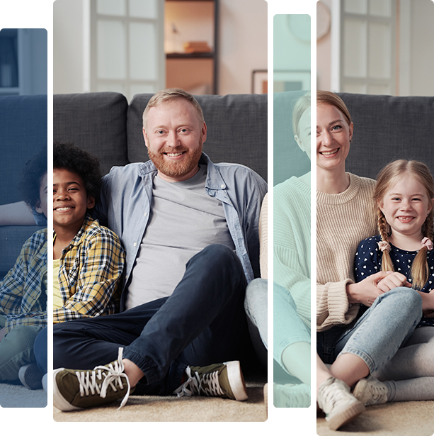 Family sitting by a couch smiling