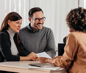 Couple at a desk talking to representative 