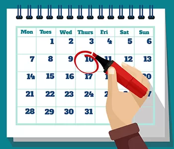 Hand circling date on calendar